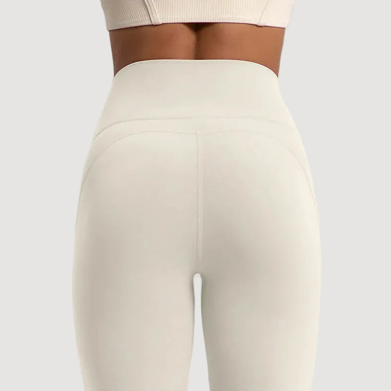 white leggings worn by a person on a light gray background