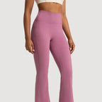 Person wearing pink flared pants on a clear background