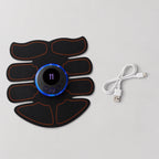 An electric muscle stimulator TENS unit pad with a central digital display and six black electrode strips outlined in orange, shown alongside a white USB charging cable on a light gray background.