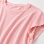 A close-up of a light pink short-sleeve crewneck t-shirt, showing the fabric texture and stitching details against a clean white background.