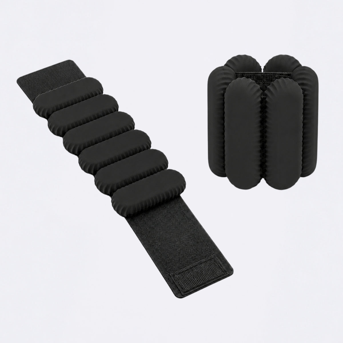 Black foam weight band with eight segmented oval weight pads and a hook-and-loop strap, shown alongside a matching set of six cylindrical foam weight bags on a light gray background.